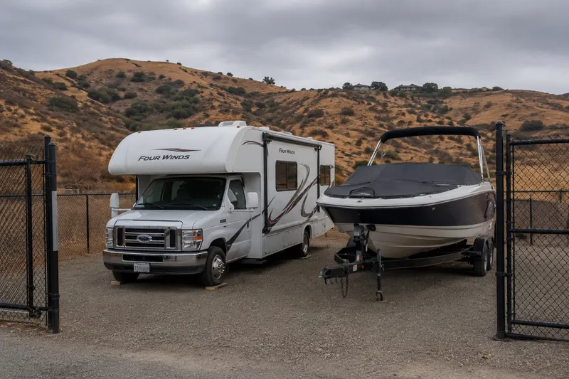 RV and boat parked in a secure storage lot during the off-season in California
