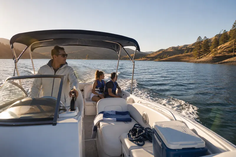 Family boating safely on a California lake with life vests on, representing liability, medical payments, and on-water towing coverage