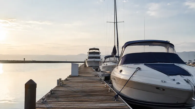 Boats moored at a Southern California marina at sunrise, representing hull, liability, and marina coverage under a boat insurance policy